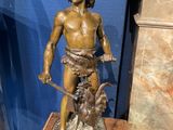 bronze statue of a boy with a dog and a cat on a pedestal