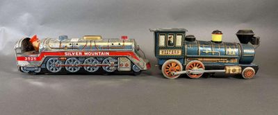 deux petits trains assis l'un à côté de l'autre sur une table