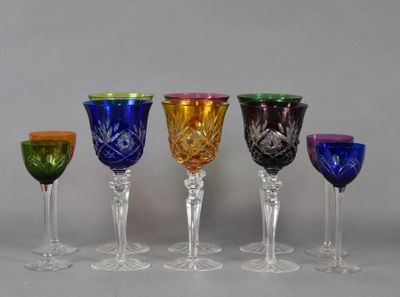 six different colored wine glasses are lined up in a row