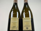 pair of two bottles of wine sitting next to each other on a white surface