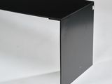 black glass desk with metal legs on a white background