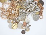 a pile of assorted jewelry on a white surface