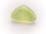 yellow jade stone on a white surface with a white background