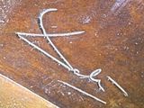 a close up of a piece of wood with some writing on it