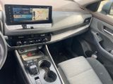 the interior of a car with a touch screen and steering controls