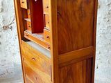 a small wooden cabinet with a drawer on wheels