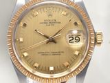 an image of a watch with a gold dial on a tan leather strap