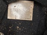 a close up of a black bag with a tag on it