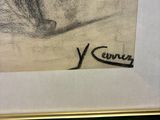 a drawing of a woman ' s face is shown in a gold frame