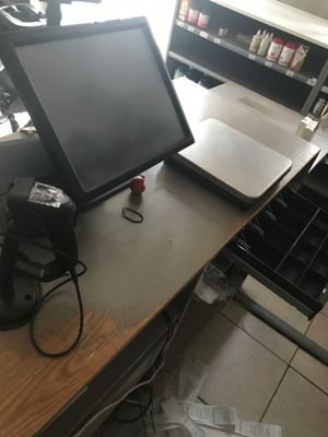 a desk with a monitor and a printer on it