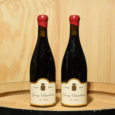 deux bouteilles de vin posées sur un tonneau