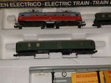 three model trains on display in a display case