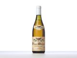 a bottle of white wine sitting on top of a table