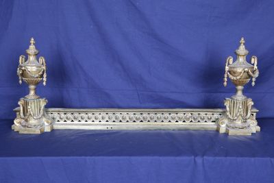 pair of antique silver plated urns on a blue background