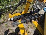 a machine that is sitting on the ground next to the grass