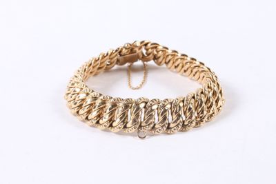a close up of a gold bracelet on a white background