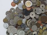 a pile of coins sitting on top of a pile of money