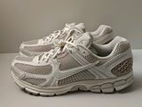 the shoe is white and has a mesh design on the sole