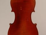 an old violin hanging from a string on a white background