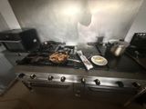 a lot of food that is on the stove in the kitchen