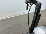 a close up of a motorcycle handlebar with a hose attached to the handlebar