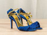 a close up of a pair of blue high heels on a table