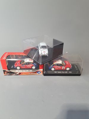 three toy cars that are in a box on a table