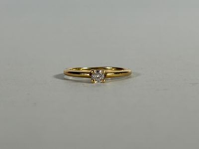 a close up of a gold ring with a diamond on it
