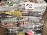 a pile of newspapers on a pallet in a warehouse