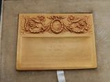 a gold plaque in a case with a ribbon around it