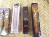 a close up of three different makeup products on a table