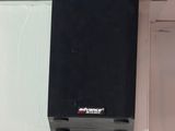 a black speaker that is on the side of a wall