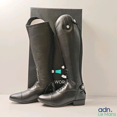 black leather riding boots with a black box on a white surface