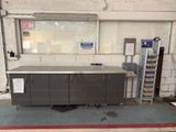 a metal workbench in the middle of a room