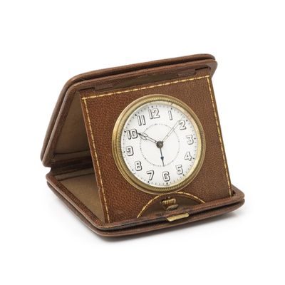 a small clock sitting on top of a brown case
