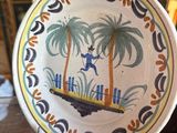 a plate that has a picture of a man on a boat on it