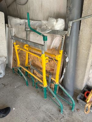 a man standing next to a pile of wood in a garage