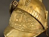 a gold helmet with a bird on top of it