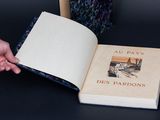 a person holding an open book with a picture on it