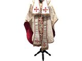 a close up of a priest ' s robe on a mannequin stand