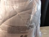 a pillow that is wrapped in plastic on a table