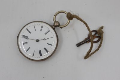 a small pocket watch with a rope hanging from it ' s side