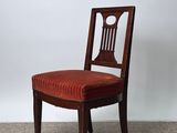 a wooden chair with a red upholstered seat