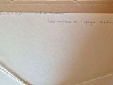 a piece of paper with writing on it sitting on a table