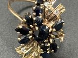 an image of a close up of a gold ring with black and white stones