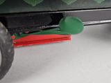 a close up of a toy truck with a green spoon on it