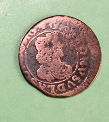 an old copper coin with a picture of a woman on it