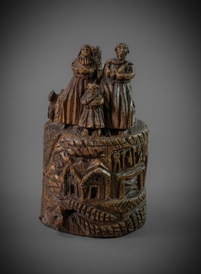 an old bronze figurine of a group of people on a rock