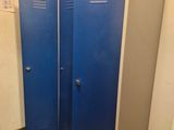 two blue lockers in the corner of a bathroom
