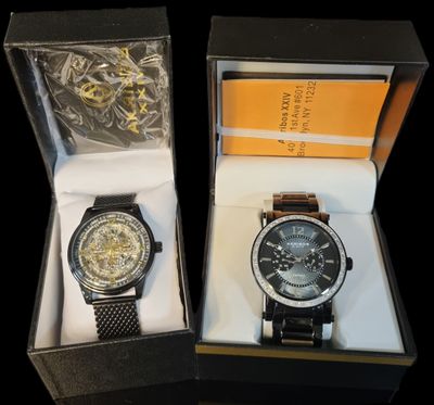 two watches that are in a box on the table